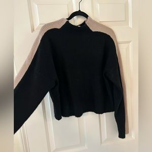 Line and dot black sweater with beige stripe down sleeve.  Size xtra small